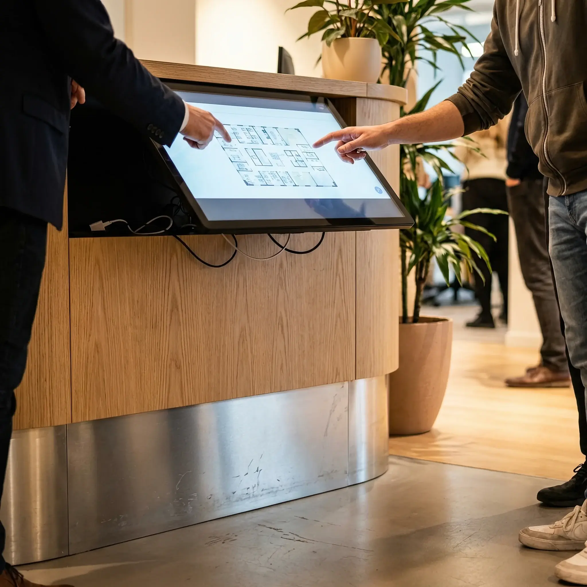 Interior detail: Administrator and co-working resident discussing a project at the open part of the reception desk