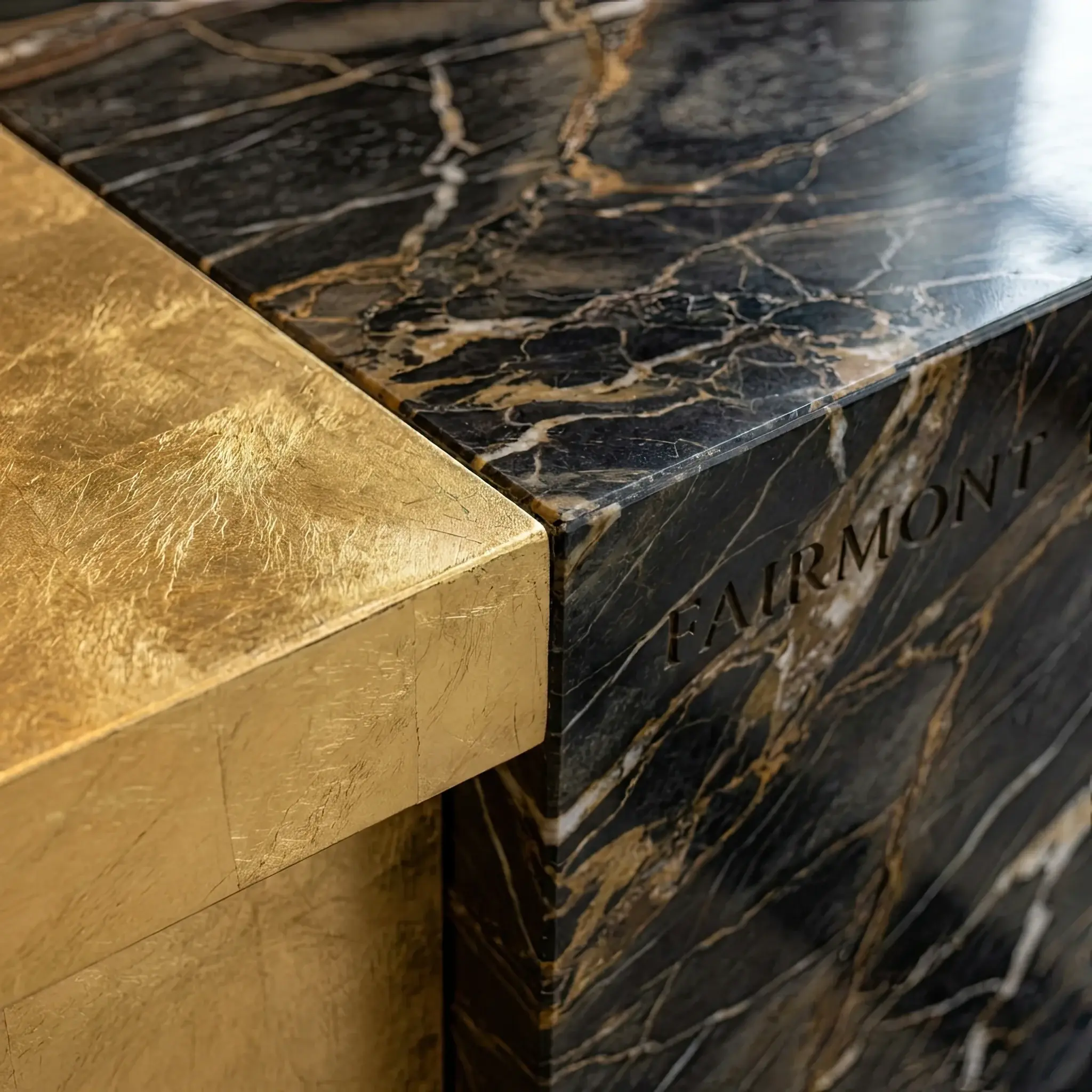 Interior detail: Concrete reception facade with wooden formwork imprints and an integrated logo